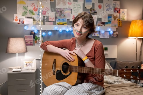 Preview: Sick teenage girl with guitar sitting at hospital ward