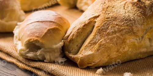 Preview: Freshly baked bread on burlap dark wooden background