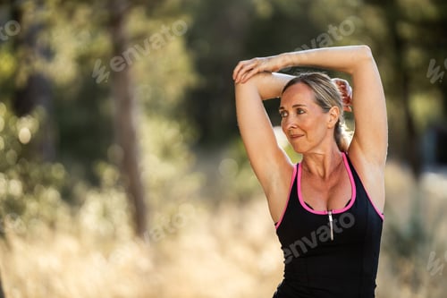Preview: Woman Doing Stretching Exercises During Training In Park At Summer Day
