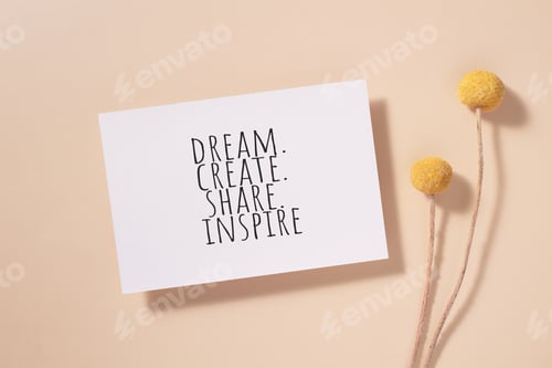 Preview: Dream, create, share, inspire words written on card. Invitation card with craspedia flowers on beige