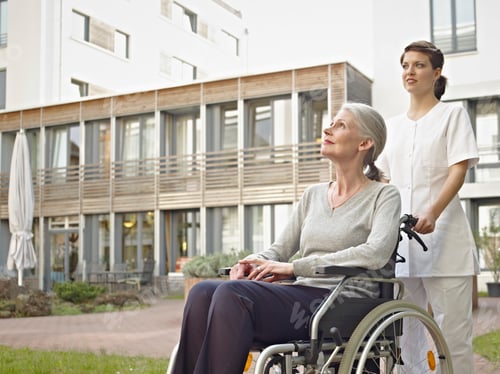 Preview: Germany, Cologne, Caretaker pushing senior women in wheelchair