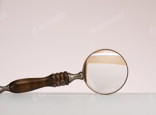 Preview: Wooden magnifier on a white background. The concept of uncertainty