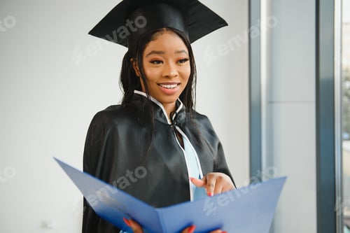 Preview: African American graduate holding diploma.
