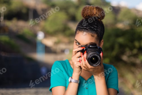 Preview: African American woman photographer taking outdoor photos - Black people
