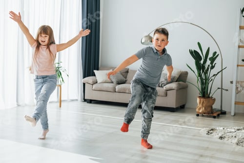 Preview: Active weekend time spending. Kids having fun in the domestic room at daytime together