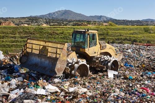 Preview: Heavy machinery shredding garbage in an open air landfill. Pollution