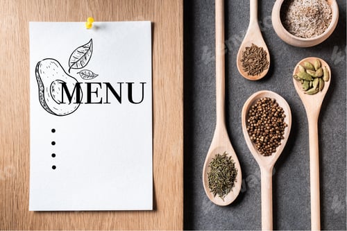 Preview: top view of dried spices on wooden spoons and paper sheet with menu inscription