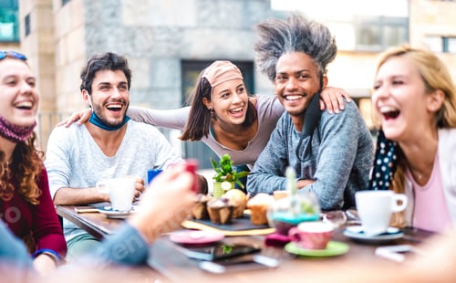 Preview: Multiracial friends having fun drinking together at coffee house