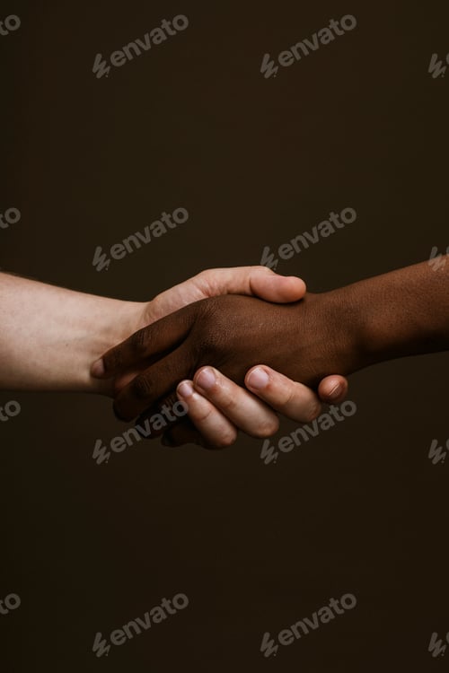 Preview: Black hand holding the white hand