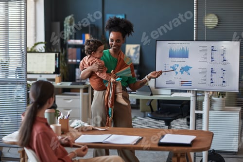 Preview: Working Mother Presenting Data while Holding Baby