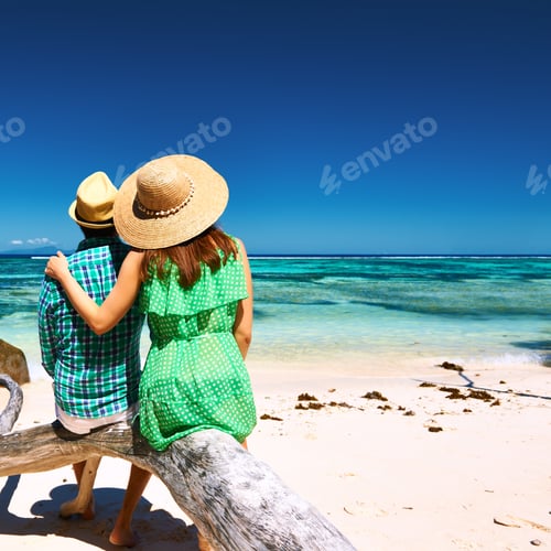 Preview: Couple Relaxing On A Tropical Beach Anse Source D'Argent At Seychelles, La Digue.