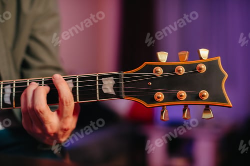 Preview: Musician composing music playing electric guitar at home