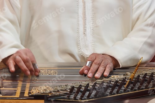 Preview: Traditional folk moroccan musician with wooden string instrument. Qanun