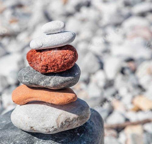 Preview: Zen balance stones, smooth rocks pyramid stacked on pebble beach background.