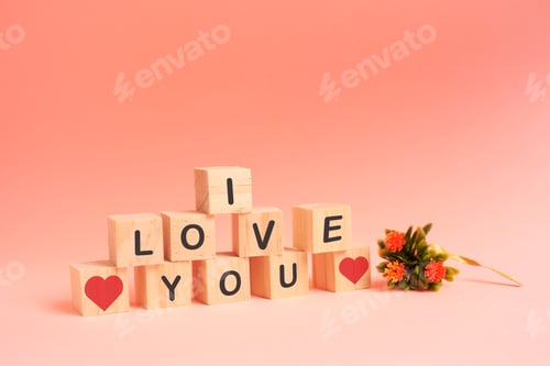 Preview: The word "I love you". made of wood blocks. and a bouquet of flowers