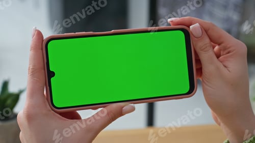 Preview: Hands holding horizontal mockup mobile phone at corporate workplace closeup