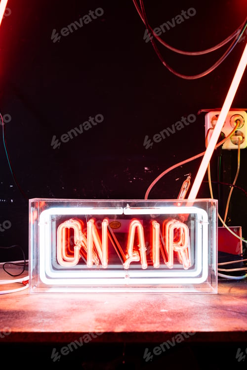 Preview: Illuminated Neon Sign Displaying On Air in a Studio Setting