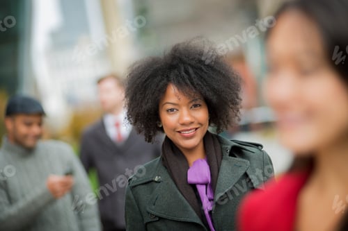 Preview: A group of people using mobile phones, and talking to each other. Men and women.