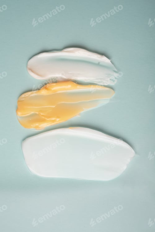 Preview: Close-up samples of cosmetic products on a blue background. Self-care trend