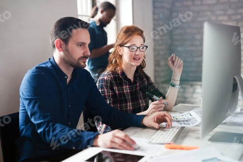 Preview: Portrait of young designers working on computer