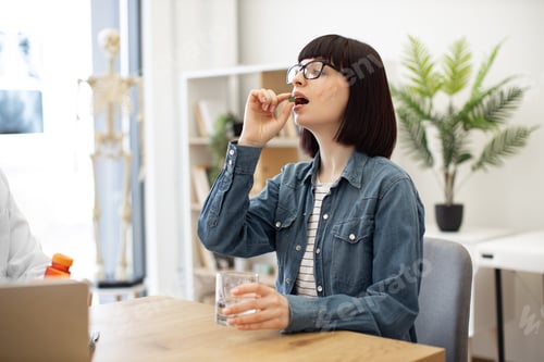 Preview: Woman taking pill due to prescription of family doctor