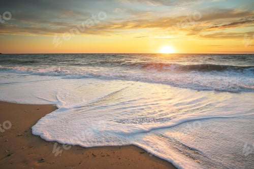 Preview: Sandy seashore at sunset.