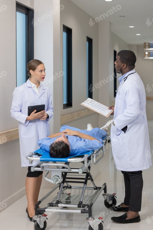 Preview: Two Doctors Discussing Patients' Medical History in Hospital Corridor