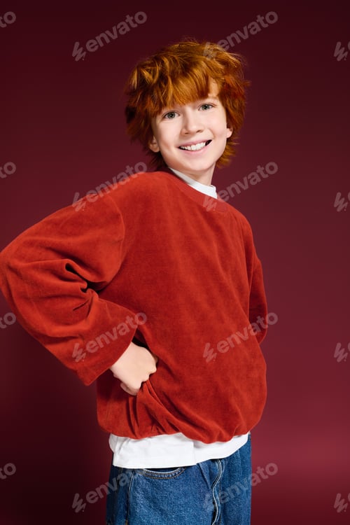 Preview: Bright style and cheerful spirit of a redhead boy in fashion studio setting