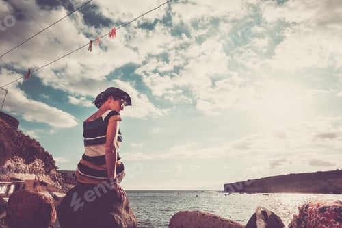 Preview: Loneliness and depression concept image with one young woman sit down alone at the beach