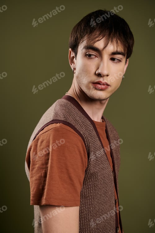 Preview: Elegant Man Posing in Knitted Vest Against Vibrant Green Background