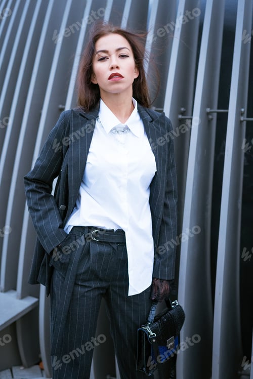 Preview: Beautiful business woman in a suit is posing