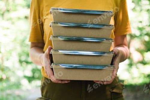 Preview: Unrecognizable person holds boxes of food in his hands. Food delivery.