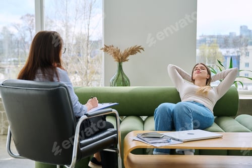 Preview: Relaxed young woman lying on sofa in psychologist office at therapy session