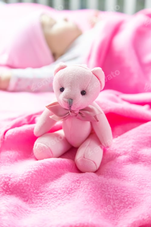 Preview: Baby sleeps with a bear. Selective focus.
