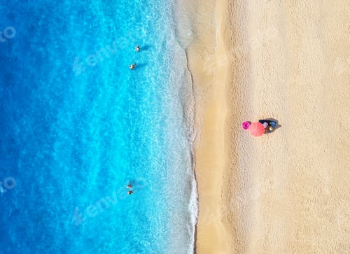 Preview: Aerial view of blue sea, sandy beach, umbrella, swimming people