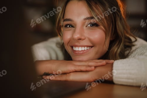 Preview: Smiling young woman in earphones watching webinar