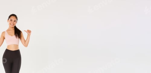 Preview: Full length of professional fitness coach, asian girl athelte pointing at herself and smiling happy