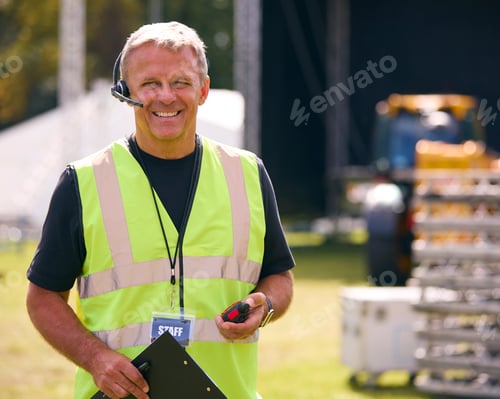 Preview: Portrait Of Male Production Worker Setting Up Outdoor Stage For Music Festival Or Concert