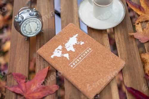 Preview: Planning adventures with notebook, coffee, and alarm clock in autumn