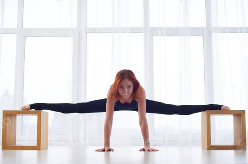 Preview: Beautiful young woman practices yoga asana at the yoga studio
