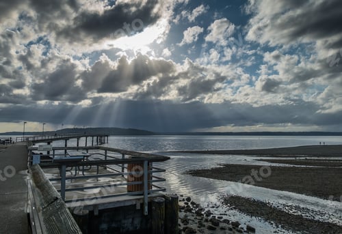 Preview: Rays Of Sunlight Break Through The Clouds Over The Pier At Des Moines, Washington.