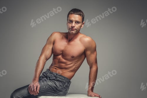 Preview: Shirtless muscular middle age man in a jeans.