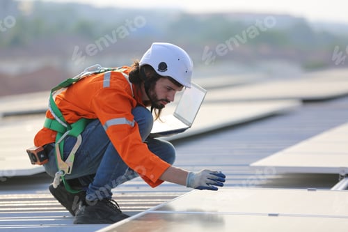 Preview: Professional worker installing solar panels on the roof of a house.