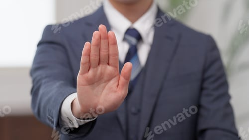 Preview: Hands of a businessman showing his palm
