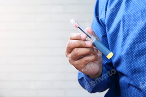 Preview: hand holding Insulin pens with copy space, Top down