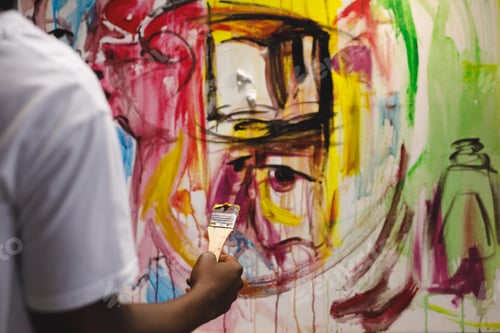 Preview: African american male painter at work painting on canvas in art studio