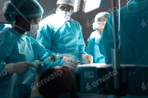 Preview: Diverse surgeons wearing surgical gowns operating on patient in operating theatre at hospital