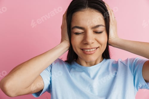 Preview: Young hispanic woman smiling and covering her ears