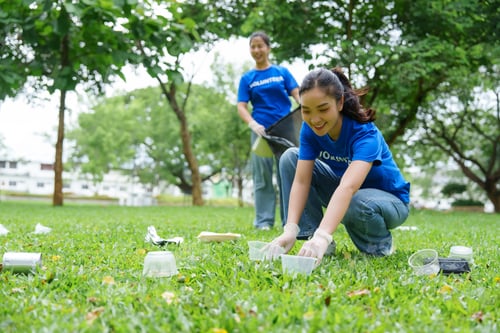 Preview: Volunteers collecting trash in public park cleaning day