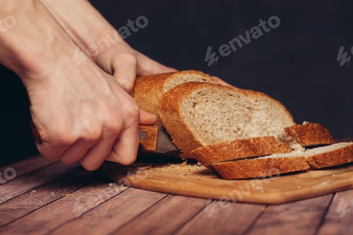 Preview: slicing fresh bread on a wooden cutting board breakfast meal